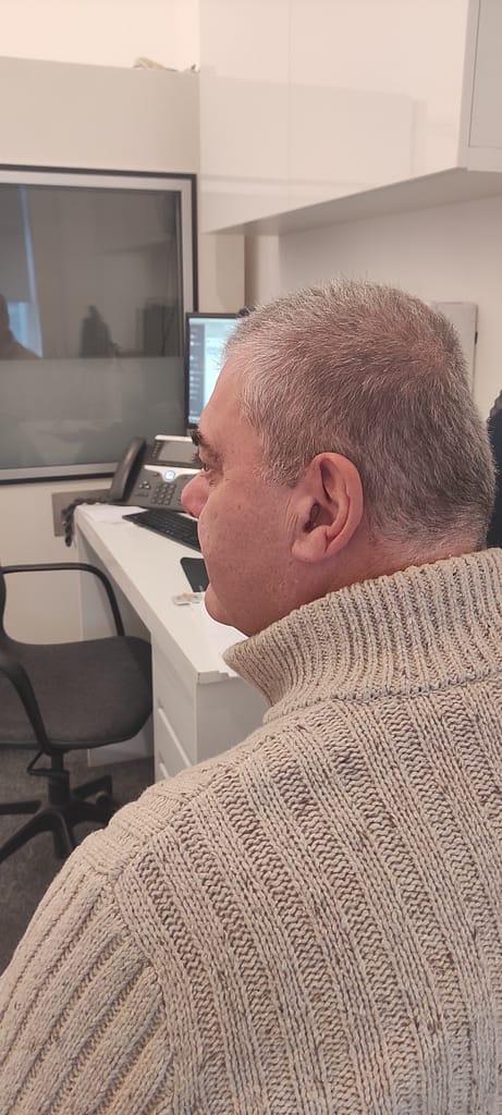 Veteran Grant Hues in audiologist's office supported with a new pair of hearing aids.