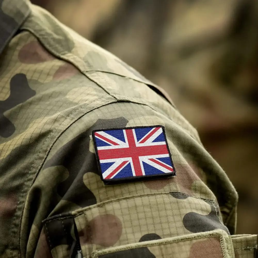 Close up of British flag on soldier's uniform.